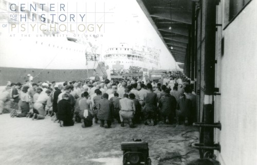 written on back of photograph: "Docked in Yokosuka @ Announcement of end of War. I held prayers of thanks for our crew AH-13 and other ships docked 8-6-45"